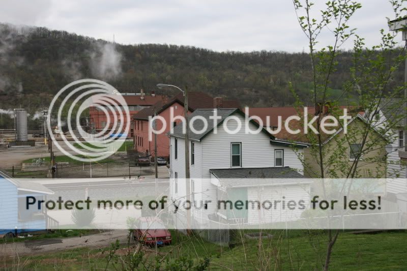 view from property neighbors across street paved alley way at rear of